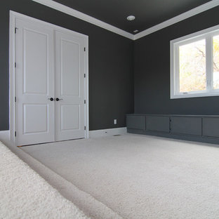 Large elegant enclosed carpeted home theater photo in Raleigh with gray walls and a wall-mounted tv