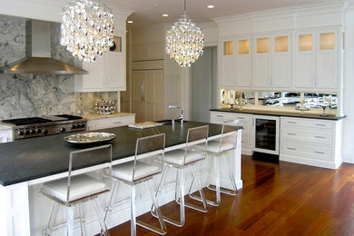 Transitional u-shaped open concept kitchen photo in New York with an undermount sink, shaker cabinets, white cabinets, quartzite countertops, gray backsplash, stone slab backsplash and paneled appliances