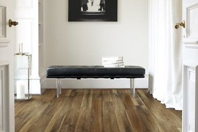 Hallway - mid-sized modern medium tone wood floor hallway idea in Indianapolis with beige walls