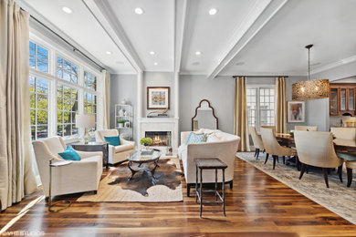 Example of a classic coffered ceiling living room design in Chicago with gray walls and a stone fireplace