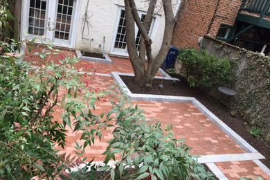 Photo of a backyard patio in DC Metro with brick pavers.
