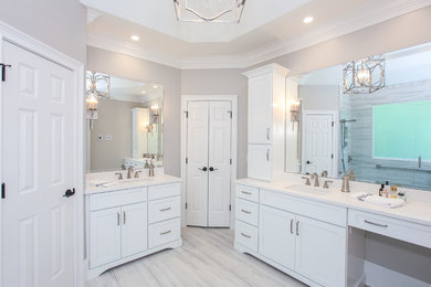 Example of a mid-sized transitional master porcelain tile and gray floor alcove shower design in Atlanta with recessed-panel cabinets, white cabinets, gray walls, an undermount sink, a hinged shower door and white countertops