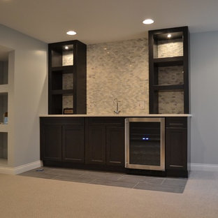 Large traditional fully buried basement in Chicago with beige walls, carpet, a wood burning stove, a brick fireplace surround and beige floors.