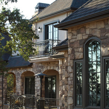 French-Country Home with Stone (rear exterior)
