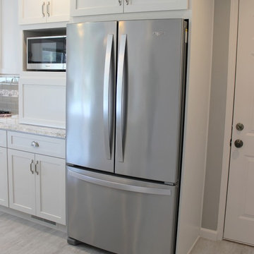 Alpha, IL White and Gray Kitchen with Hidden Laundry and Raised Dishwasher