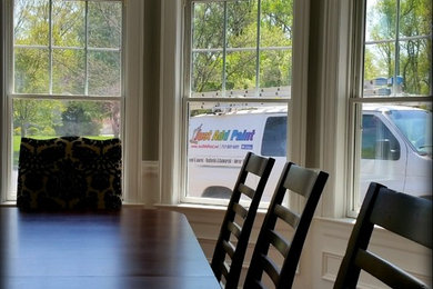 Large trendy dark wood floor dining room photo in Other with beige walls