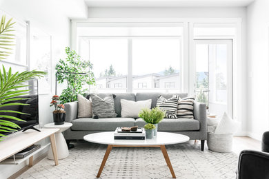 Small trendy open concept vinyl floor living room photo in Vancouver with gray walls and a tv stand