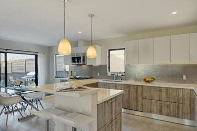 Eat-in kitchen - huge contemporary eat-in kitchen idea in San Diego with stainless steel appliances and an island