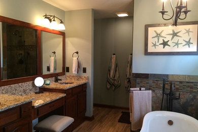 Bathroom - mid-sized traditional master multicolored tile and stone tile porcelain tile bathroom idea in Columbus with raised-panel cabinets, medium tone wood cabinets, a two-piece toilet, green walls, an undermount sink and granite countertops