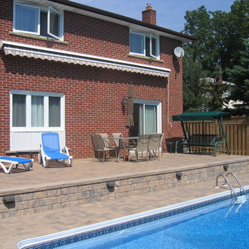 Retractable awning over patio by the pool