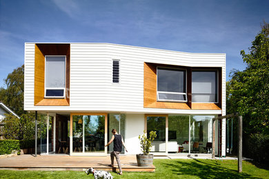 Inspiration for a contemporary one-storey white exterior in Hobart with wood siding.