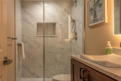 Inspiration for a modern 3/4 porcelain tile, gray floor and single-sink bathroom remodel in Denver with shaker cabinets, brown cabinets, a one-piece toilet, beige walls, a drop-in sink, quartz countertops, beige countertops, a niche and a floating vanity