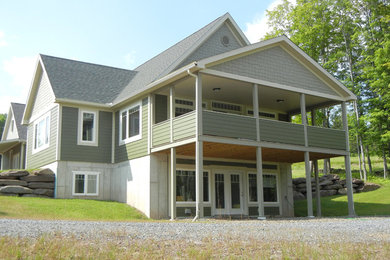 Example of a large gray two-story exterior home design in New York