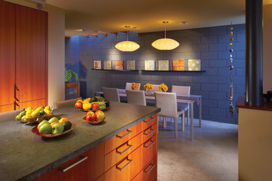 Inspiration for a contemporary eat-in kitchen in Orange County with flat-panel cabinets and medium wood cabinets.