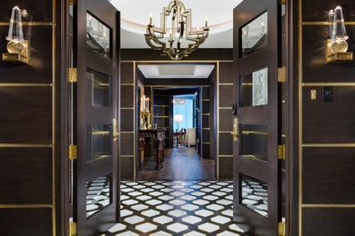 Example of a large transitional marble floor, white floor and wall paneling entryway design in Miami with brown walls and a brown front door