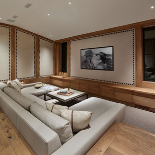 Home theater - rustic enclosed carpeted home theater idea in San Francisco with a wall-mounted tv