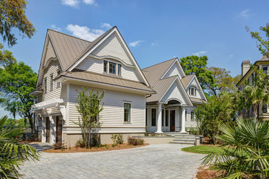 Inspiration for a large transitional beige two-story concrete fiberboard gable roof remodel in Charleston