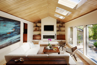 Living room - contemporary living room idea in San Francisco with beige walls, a ribbon fireplace and a wall-mounted tv