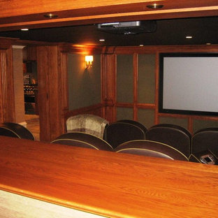 Inspiration for a mid-sized timeless enclosed carpeted and beige floor home theater remodel in Bridgeport with brown walls and a media wall