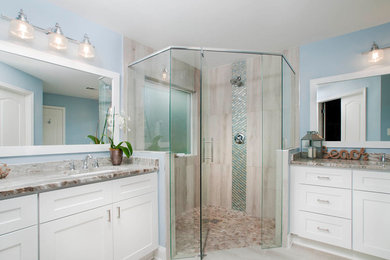 Mid-sized beach style master bathroom in Atlanta with shaker cabinets, white cabinets, a corner shower, beige tile, blue tile, porcelain tile, blue walls, an undermount sink, granite benchtops, beige floor and a hinged shower door.