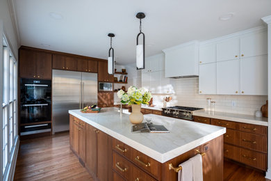 Example of a large transitional brown floor and light wood floor eat-in kitchen design in DC Metro with a farmhouse sink, flat-panel cabinets, medium tone wood cabinets, beige backsplash, an island, beige countertops, marble countertops, porcelain backsplash and stainless steel appliances