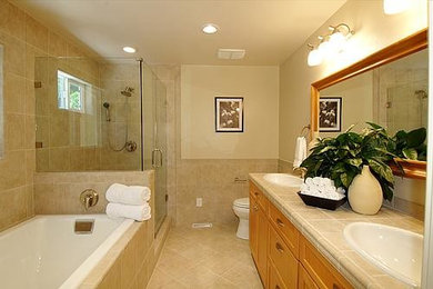 Inspiration for a mid-sized cottage master beige tile and porcelain tile ceramic tile bathroom remodel in San Francisco with a drop-in sink, shaker cabinets, light wood cabinets, tile countertops, a two-piece toilet and beige walls