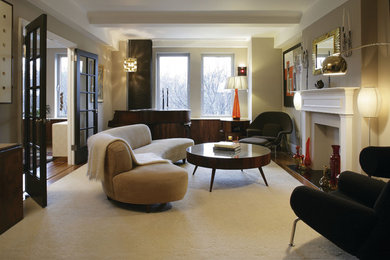 Mid-sized trendy enclosed medium tone wood floor and brown floor living room photo in New York with beige walls, a standard fireplace, a wood fireplace surround and no tv
