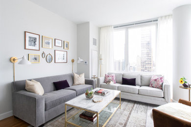 Living room - small 1960s open concept medium tone wood floor living room idea in New York with white walls, no fireplace and a tv stand