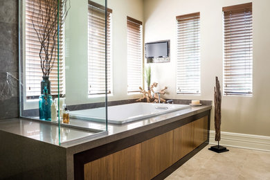 Inspiration for a large contemporary master stone tile and beige tile limestone floor bathroom remodel in Chicago with flat-panel cabinets, medium tone wood cabinets, quartz countertops, beige walls, an undermount sink and a two-piece toilet