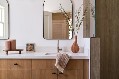 Example of a mid-sized transitional bathroom design in San Francisco with medium tone wood cabinets
