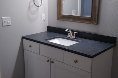 Example of a large country medium tone wood floor and gray floor bathroom design in Cedar Rapids with shaker cabinets and white cabinets