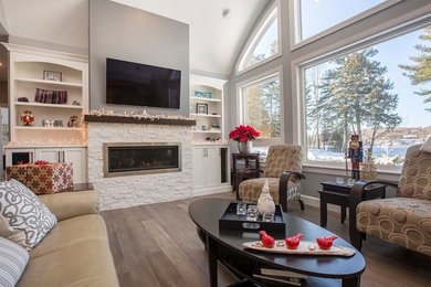 Example of a transitional medium tone wood floor and brown floor living room design in Other with a ribbon fireplace, a brick fireplace and a wall-mounted tv