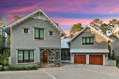 Mid-sized mountain style gray two-story wood and shingle exterior home photo in Other with a metal roof and a gray roof