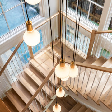 Project #152 | Three-Story White Oak Staircase with a Pendant Chandelier