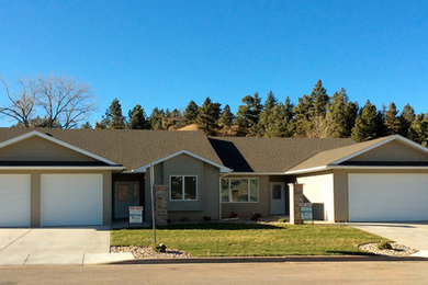 Inspiration for a large transitional beige one-story stucco gable roof remodel in Other