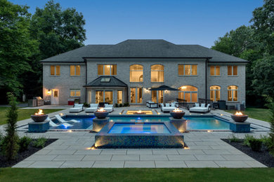 Example of a minimalist backyard concrete paver and rectangular pool design in DC Metro