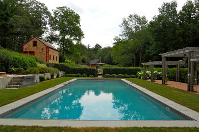 Example of a large classic courtyard brick pool design in Providence