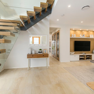 This is an example of a medium sized coastal open plan home cinema in Sydney with white walls, ceramic flooring, a built-in media unit and yellow floors.