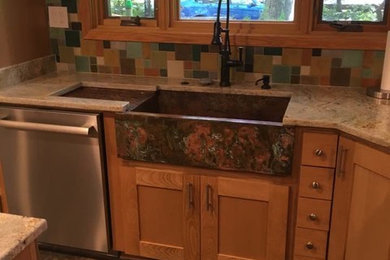 Enclosed kitchen - mid-sized eclectic u-shaped vinyl floor enclosed kitchen idea in Detroit with a farmhouse sink, shaker cabinets, light wood cabinets, granite countertops, multicolored backsplash, terra-cotta backsplash, white appliances and an island