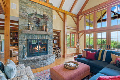 Example of a large transitional open concept light wood floor living room design in Boston with beige walls, a standard fireplace and a stone fireplace