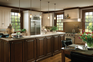 Eat-in kitchen - mid-sized transitional l-shaped medium tone wood floor eat-in kitchen idea in Chicago with raised-panel cabinets, white cabinets, granite countertops, gray backsplash, subway tile backsplash, stainless steel appliances and an island