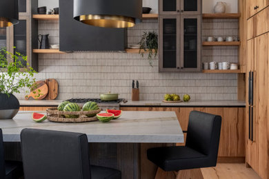 Large mountain style l-shaped light wood floor, brown floor and exposed beam eat-in kitchen photo in Seattle with a farmhouse sink, flat-panel cabinets, brown cabinets, quartzite countertops, brown backsplash, ceramic backsplash, paneled appliances, an island and gray countertops