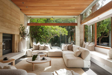 Living room - large contemporary open concept gray floor, shiplap ceiling, wall paneling and concrete floor living room idea in Los Angeles with beige walls, a standard fireplace, a stone fireplace and no tv