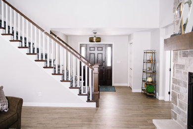 Mid-sized transitional vinyl floor entryway photo in Other with gray walls and a dark wood front door