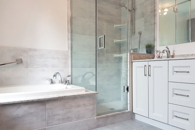 Mid-sized trendy master gray tile and porcelain tile porcelain tile and gray floor bathroom photo in Toronto with shaker cabinets, gray cabinets, an undermount sink, quartz countertops and a hinged shower door