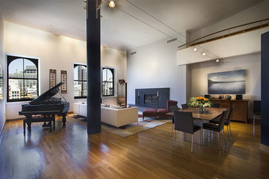 Inspiration for a large contemporary open concept light wood floor living room remodel in New York with white walls