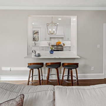 Kitchen Pass-Through with Bar Seating and Pendant Lighting