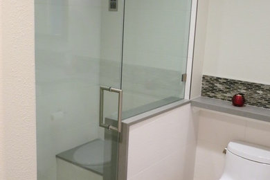 Bathroom - mid-sized modern beige tile and porcelain tile porcelain tile bathroom idea in San Francisco with flat-panel cabinets, white cabinets, a one-piece toilet, white walls and an undermount sink
