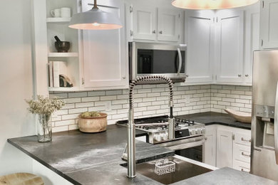 Inspiration for a country kitchen remodel in New York with shaker cabinets, white cabinets, soapstone countertops and subway tile backsplash