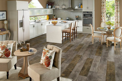 Open concept kitchen - large cottage l-shaped porcelain tile open concept kitchen idea in Orange County with an undermount sink, shaker cabinets, white cabinets, concrete countertops, gray backsplash, glass tile backsplash, stainless steel appliances and an island